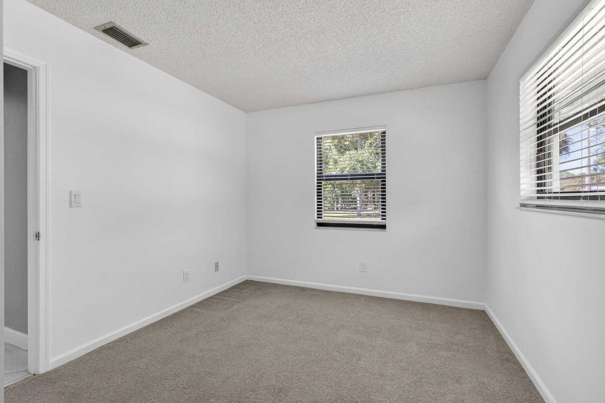 7107 181st Street Jupiter, FL 33458 - Photo 30 of 54 an empty room with windows