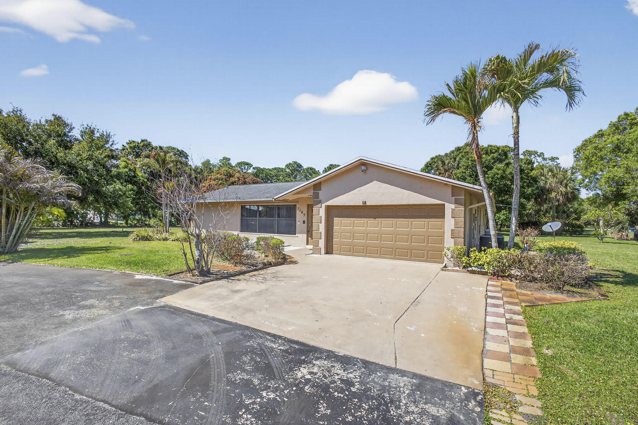 7107 181st Street Jupiter, FL 33458 - Photo 3 of 54 a view of a house with a yard and potted plants