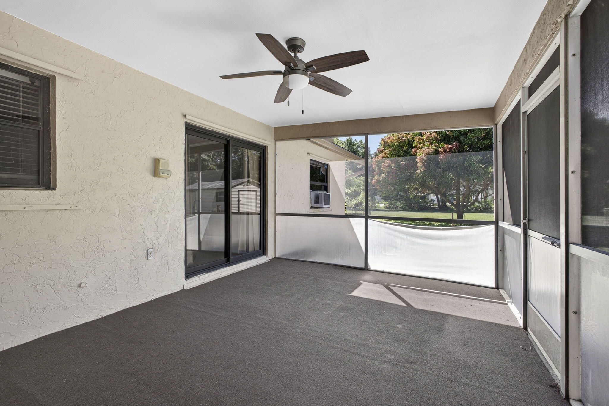 7107 181st Street Jupiter, FL 33458 - Photo 36 of 54 a view of an empty room with a ceiling fan and window
