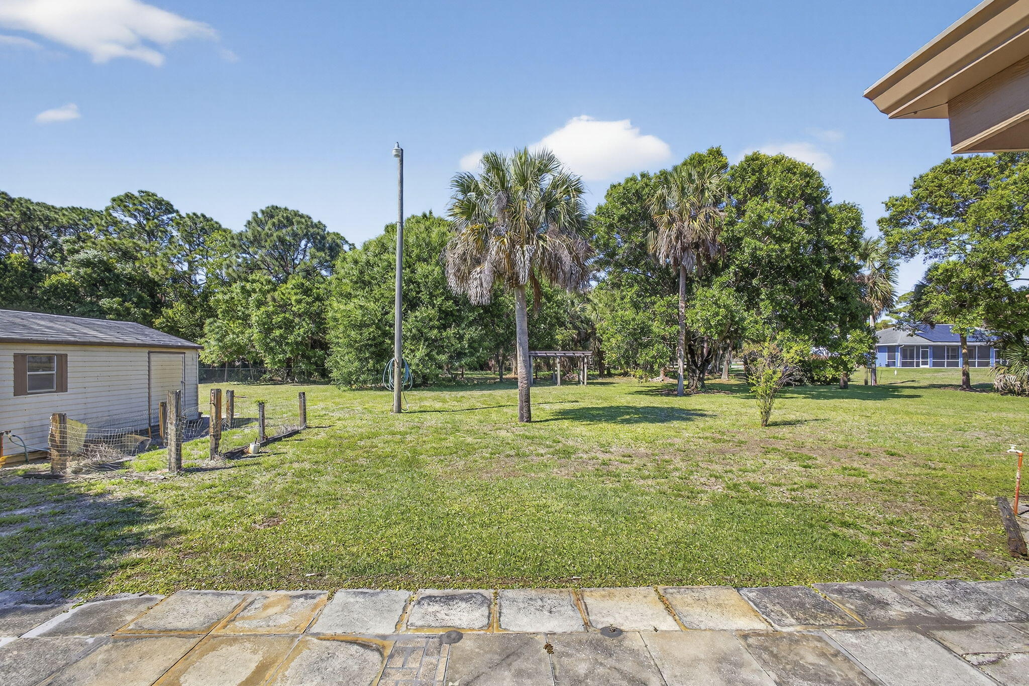 7107 181st Street Jupiter, FL 33458 - Photo 42 of 54 a view of a backyard with a garden