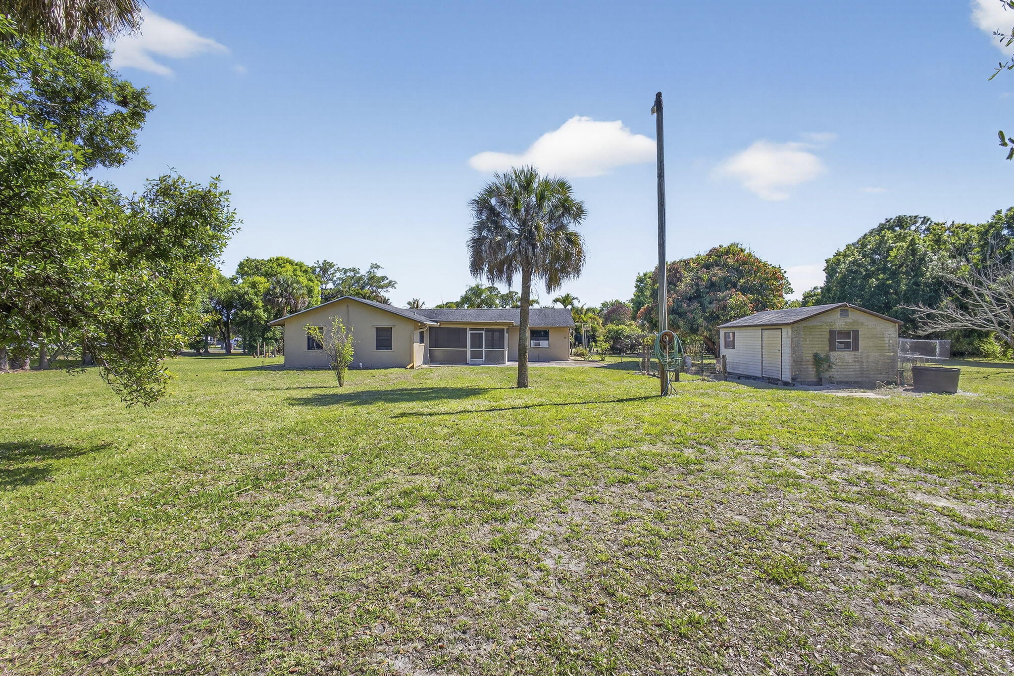 7107 181st Street Jupiter, FL 33458 - Photo 50 of 54 a view of a house with a backyard