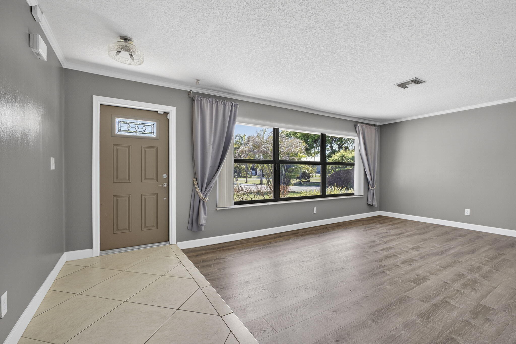 7107 181st Street Jupiter, FL 33458 - Photo 5 of 54 a view of an empty room with a window