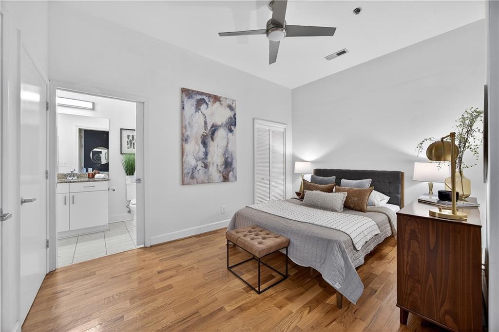 384 Ralph McGill Boulevard Northeast, Unit 322 Atlanta, GA 30312 - Photo 15 of 23 a bedroom with a bed and a chandelier