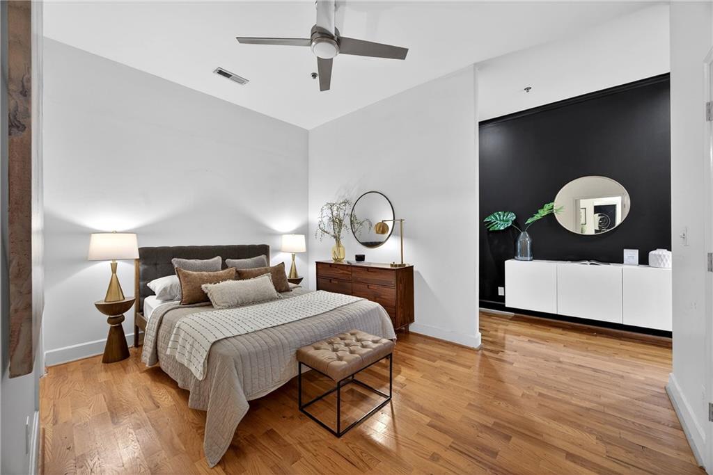 384 Ralph McGill Boulevard Northeast, Unit 322 Atlanta, GA 30312 - Photo 16 of 23 a bedroom with a bed and a chandelier
