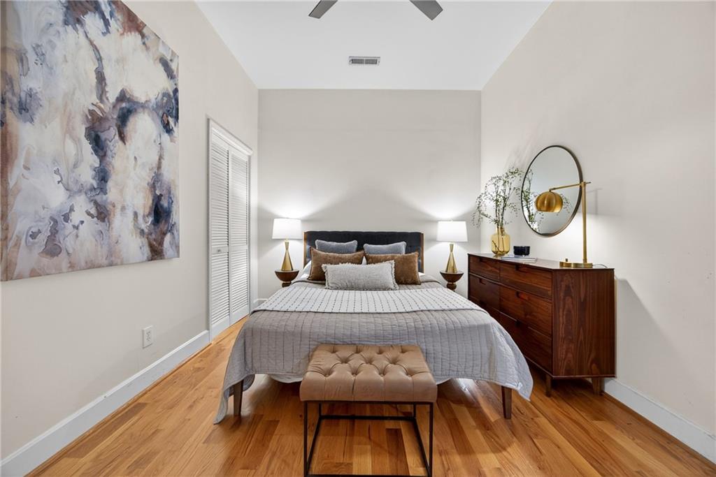 384 Ralph McGill Boulevard Northeast, Unit 322 Atlanta, GA 30312 - Photo 17 of 23 a bedroom with a bed and wooden floor