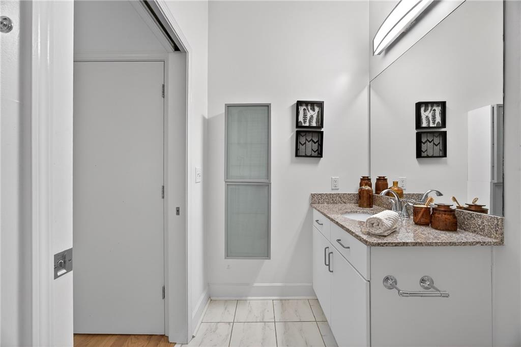384 Ralph McGill Boulevard Northeast, Unit 322 Atlanta, GA 30312 - Photo 20 of 23 a bathroom with a sink and a mirror