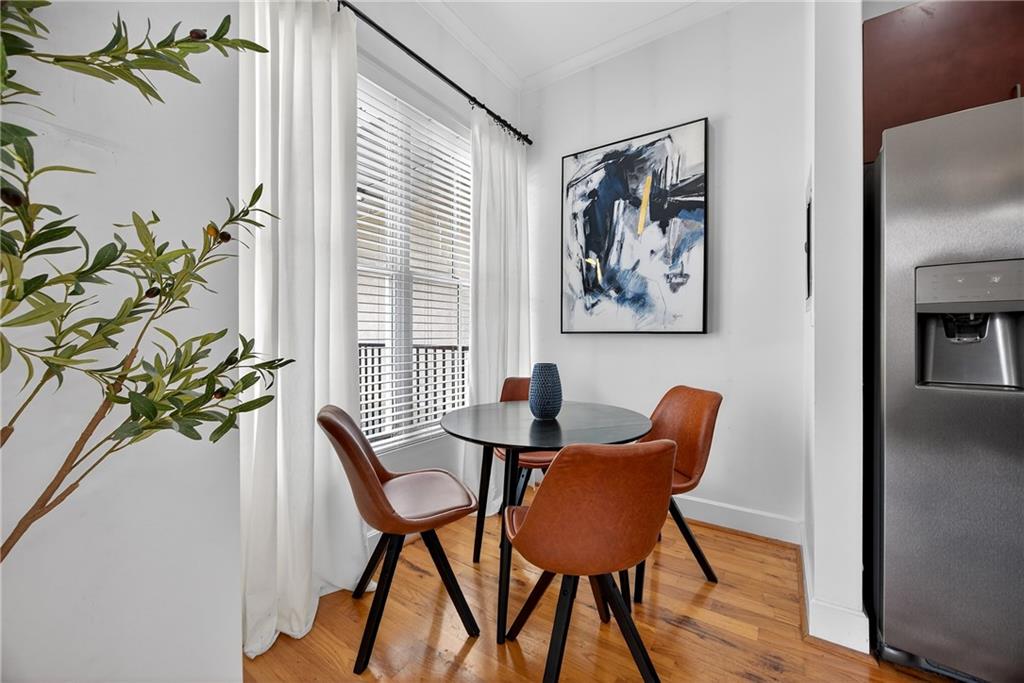 384 Ralph McGill Boulevard Northeast, Unit 322 Atlanta, GA 30312 - Photo 10 of 23 a view of a dining room with furniture and wooden floor