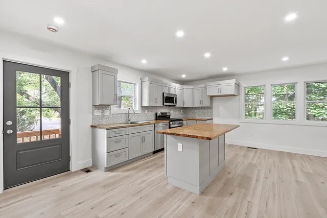 a kitchen with a stove a sink and a refrigerator