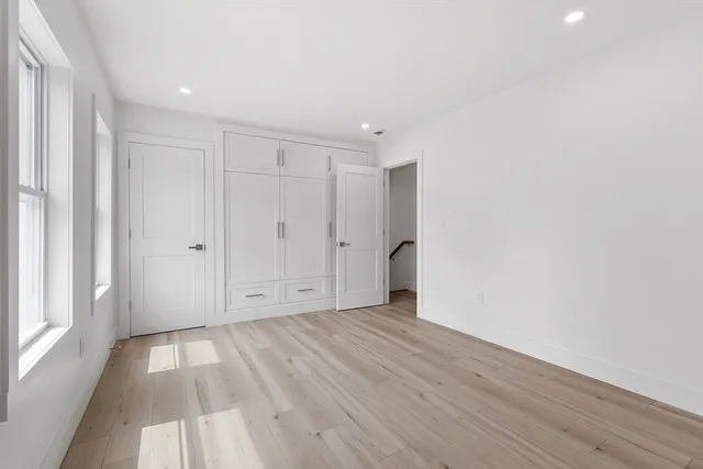 a view of an empty room with wooden floor