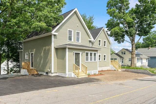 a front view of a house with a garden