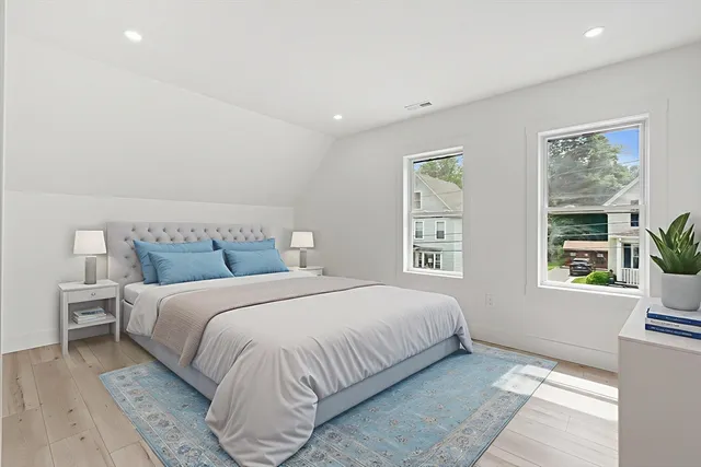 a bedroom with a large bed and a window