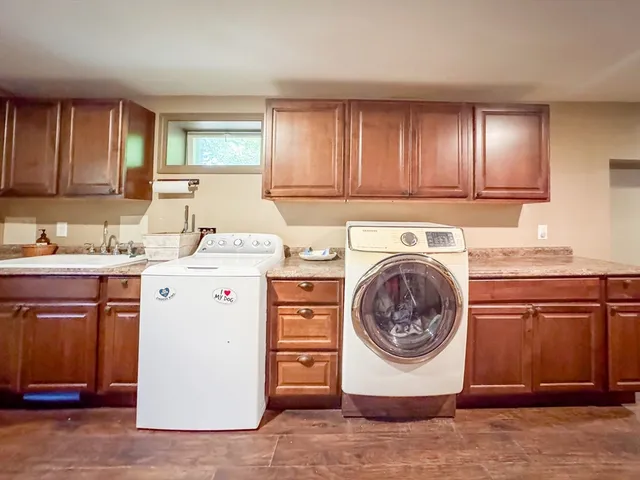 a utility room with sink dryer and washer