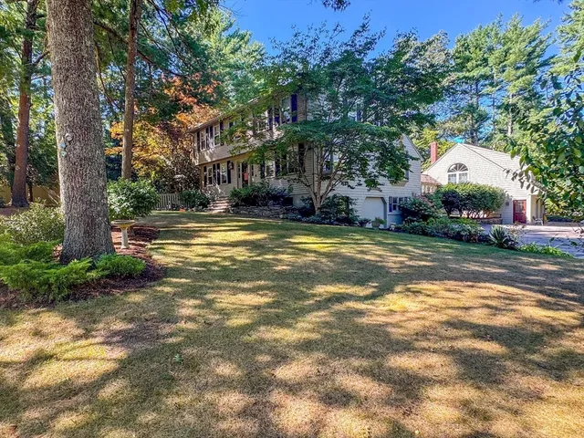 a view of a house with a yard and tree s