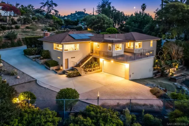 an aerial view of a house with a swimming pool outdoor seating and yard