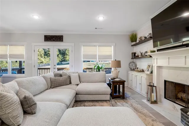 a living room with furniture a flat screen tv and a fireplace
