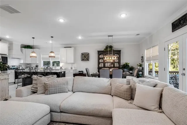 a living room with furniture kitchen and a window