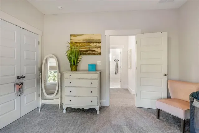 a bathroom with a granite countertop sink a toilet and mirror