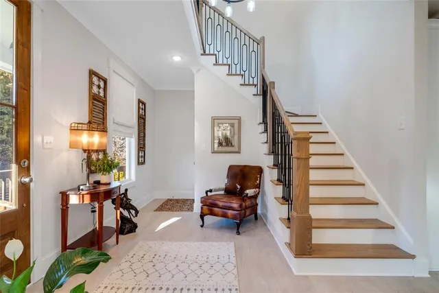 a living room with furniture and stairs
