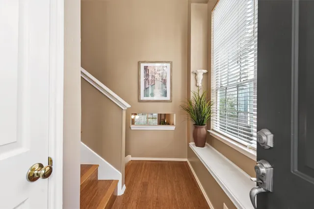 a bedroom with a bed and a flat tv screen on dresser