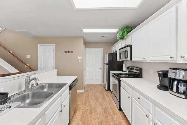a bedroom with bed and wooden floor