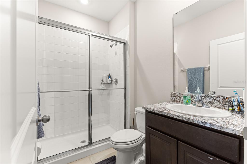 8142 Southwest 59th Avenue Ocala, FL 34476 - Photo 11 of 54 a bathroom with a granite countertop sink toilet and shower