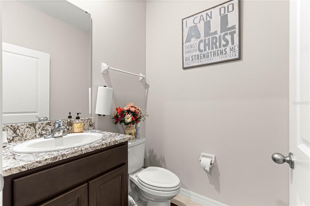 8142 Southwest 59th Avenue Ocala, FL 34476 - Photo 12 of 54 a bathroom with a granite countertop toilet sink and a mirror