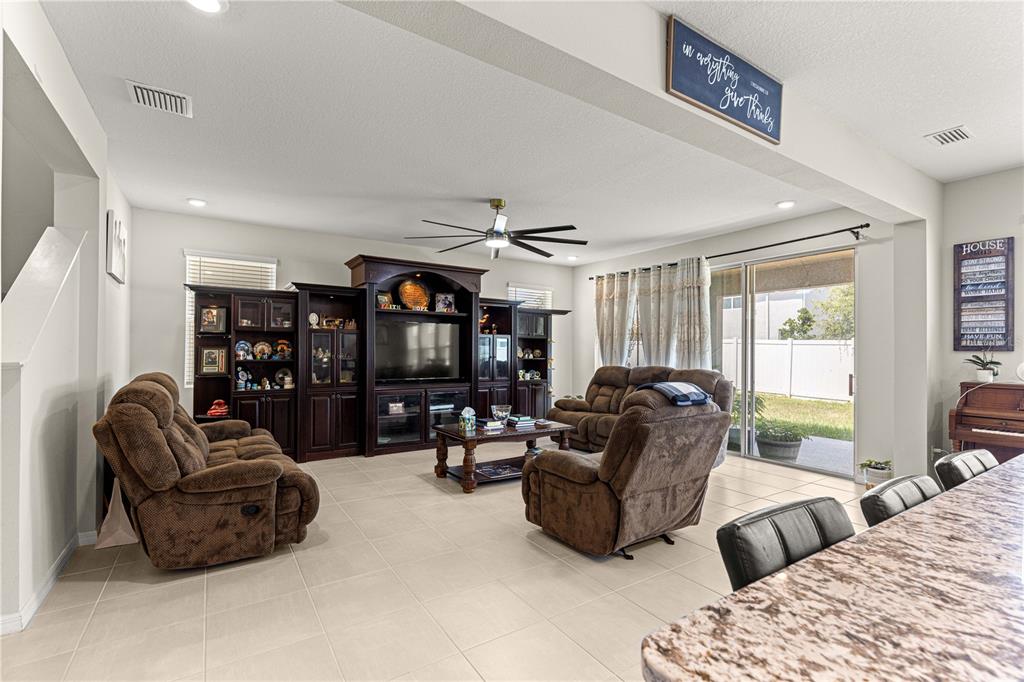 8142 Southwest 59th Avenue Ocala, FL 34476 - Photo 18 of 54 a living room with furniture a fireplace and a large window