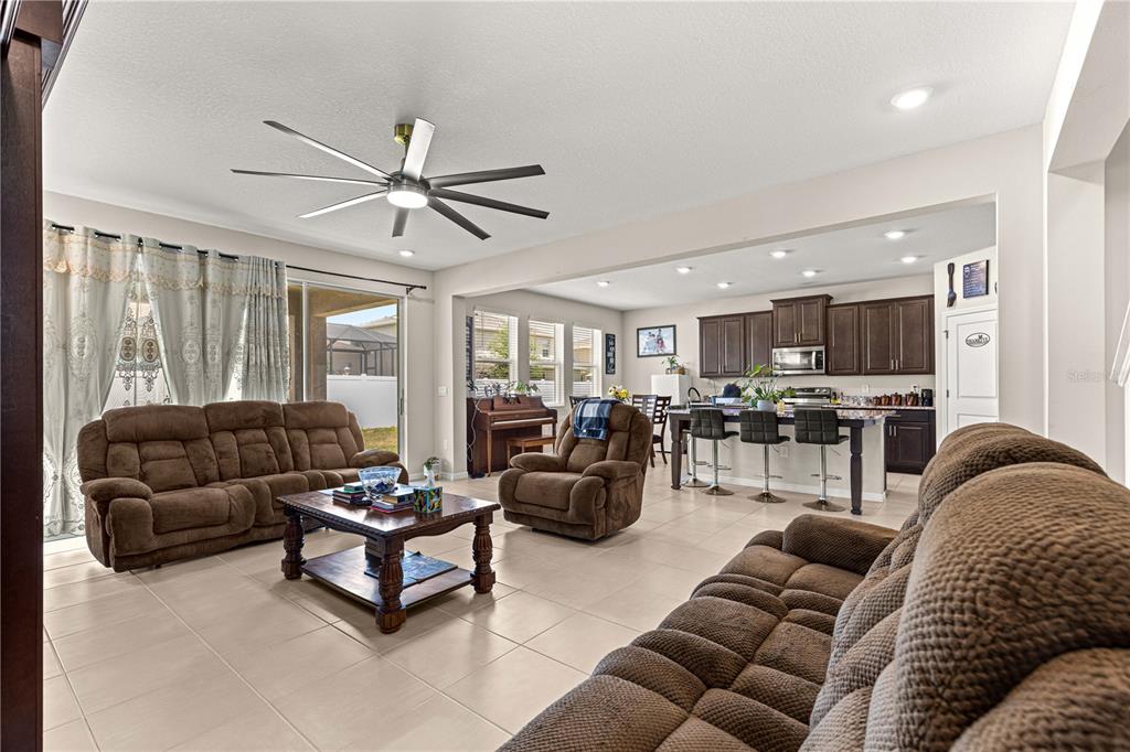 8142 Southwest 59th Avenue Ocala, FL 34476 - Photo 21 of 54 a living room with furniture ceiling fan and a window