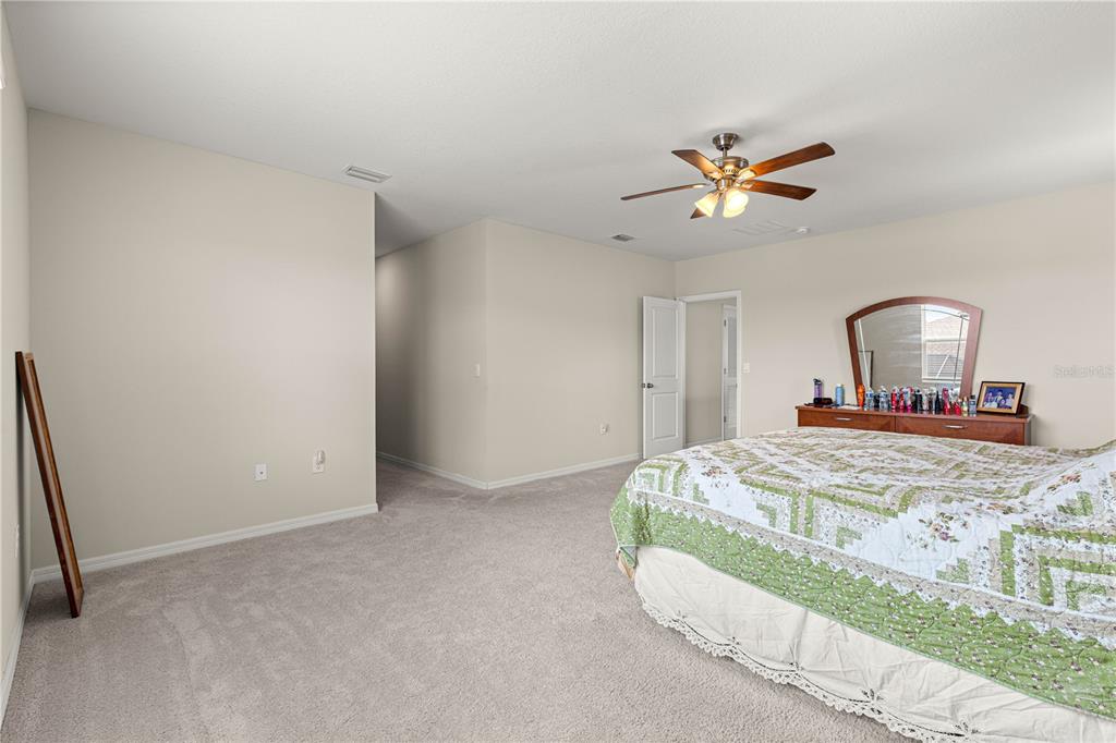 8142 Southwest 59th Avenue Ocala, FL 34476 - Photo 24 of 54 a bedroom with a bed and a mirror on dresser