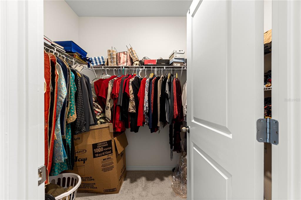 8142 Southwest 59th Avenue Ocala, FL 34476 - Photo 26 of 54 a view of walk in closet with clothes and shoes
