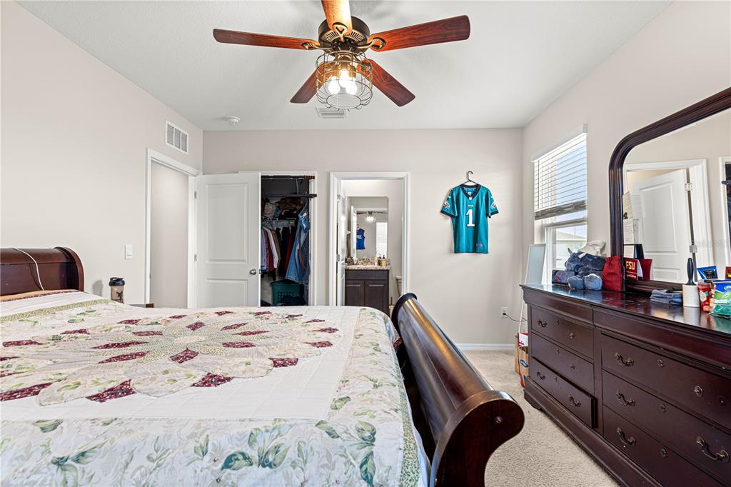 8142 Southwest 59th Avenue Ocala, FL 34476 - Photo 37 of 54 a bedroom with a bed and a dresser in it