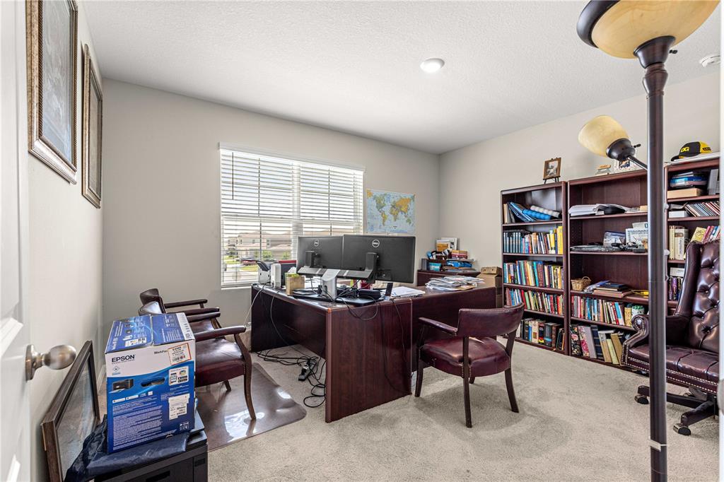 8142 Southwest 59th Avenue Ocala, FL 34476 - Photo 39 of 54 a view of a workspace with furniture and a bookshelf