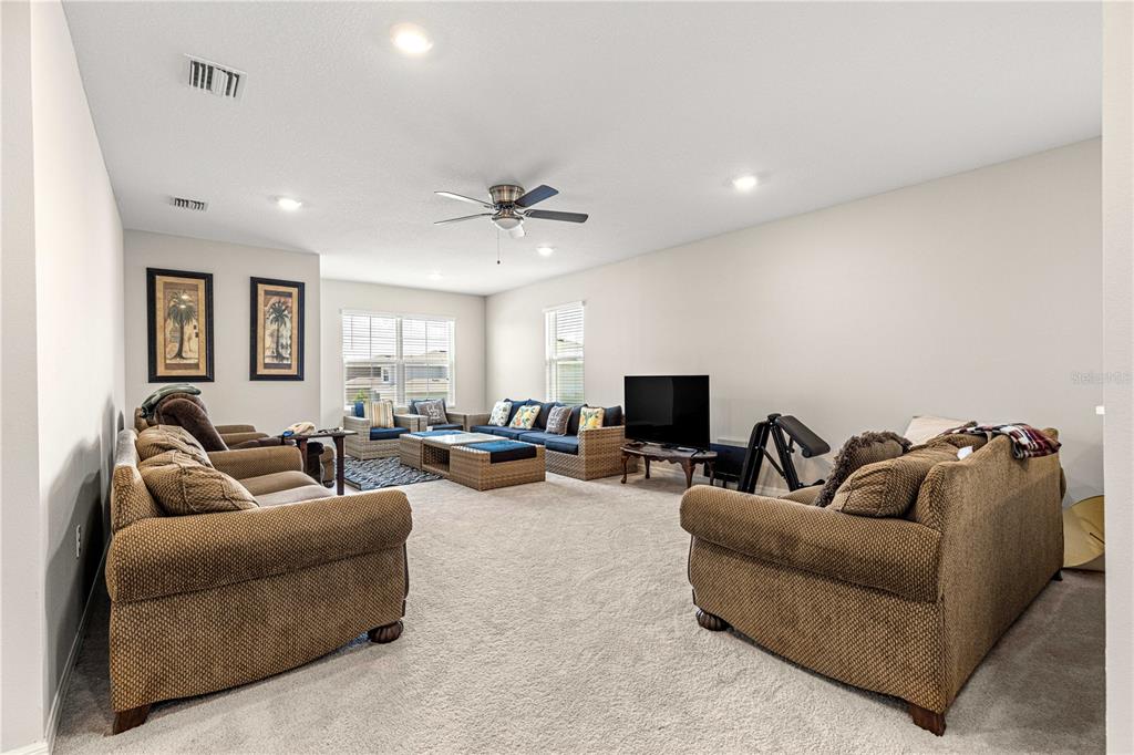 8142 Southwest 59th Avenue Ocala, FL 34476 - Photo 40 of 54 a living room with furniture and a flat screen tv
