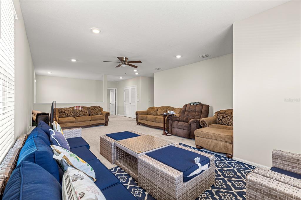 8142 Southwest 59th Avenue Ocala, FL 34476 - Photo 42 of 54 a living room with furniture and wooden floor