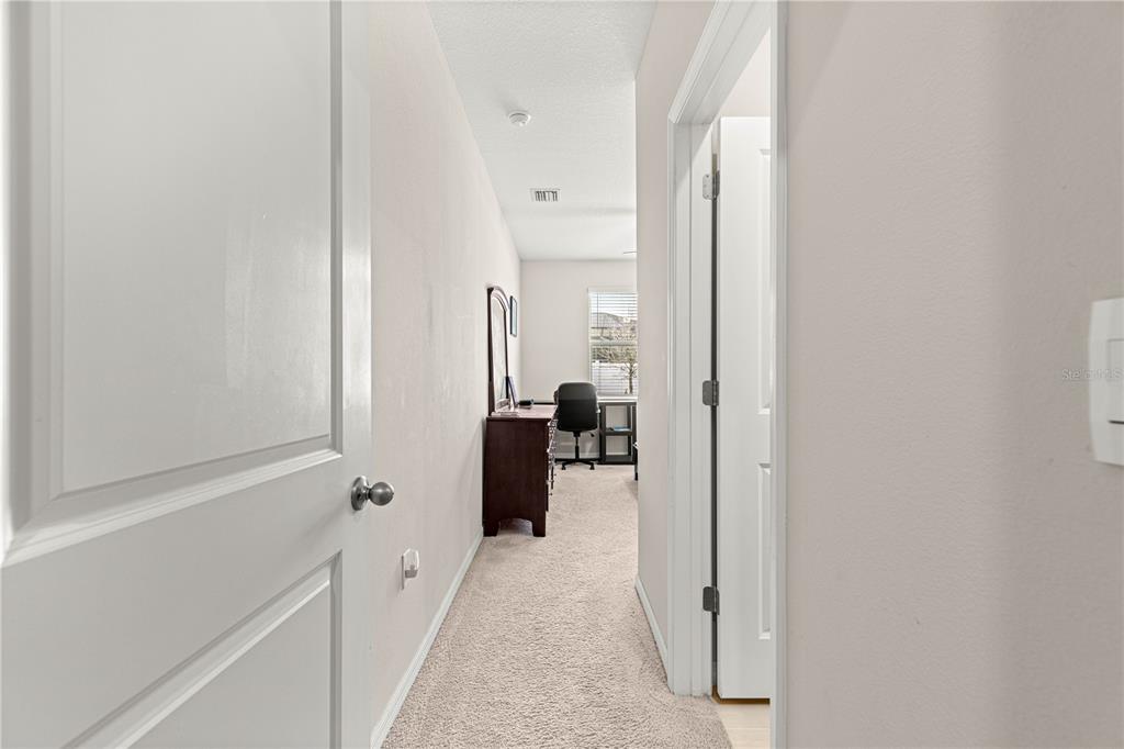 8142 Southwest 59th Avenue Ocala, FL 34476 - Photo 8 of 54 a view of a hallway with a dining area