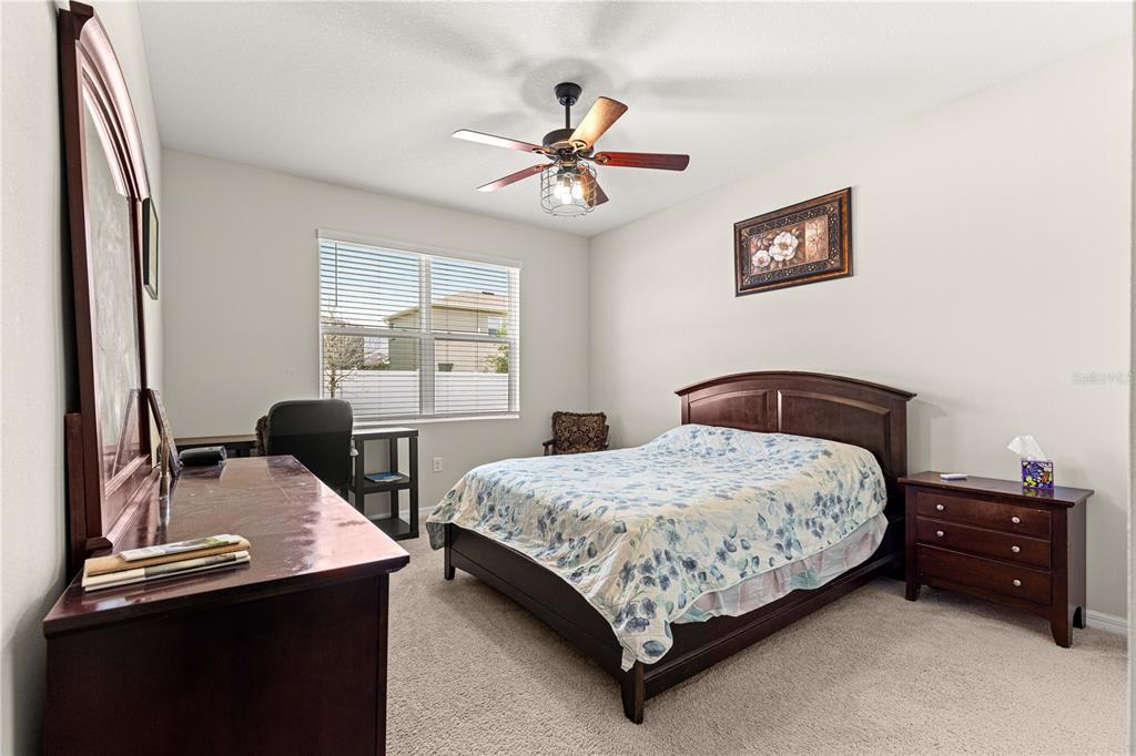 8142 Southwest 59th Avenue Ocala, FL 34476 - Photo 9 of 54 a bedroom with a bed and a desk