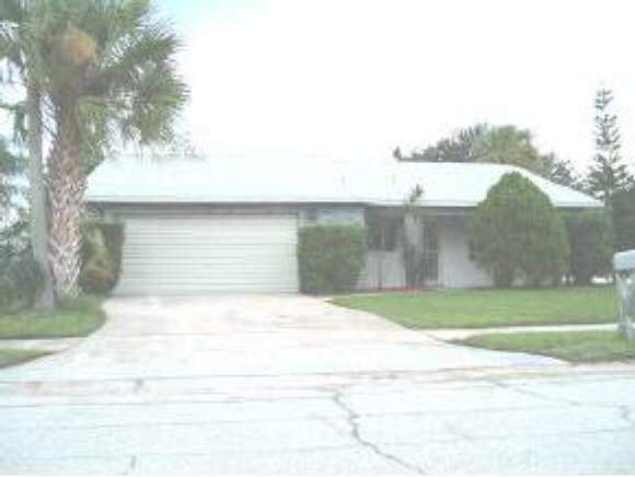 2229 Spring Cocoa Cocoa, FL 32926 - Photo 1 of 1 a front view of a house with a yard and garage