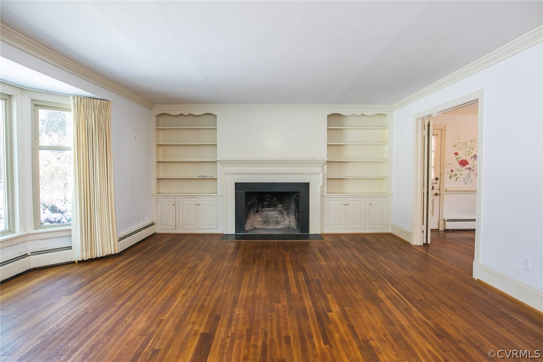 8013 Thom Road Henrico, VA 23229 - Photo 16 of 40 an empty room with wooden floor a fireplace and windows