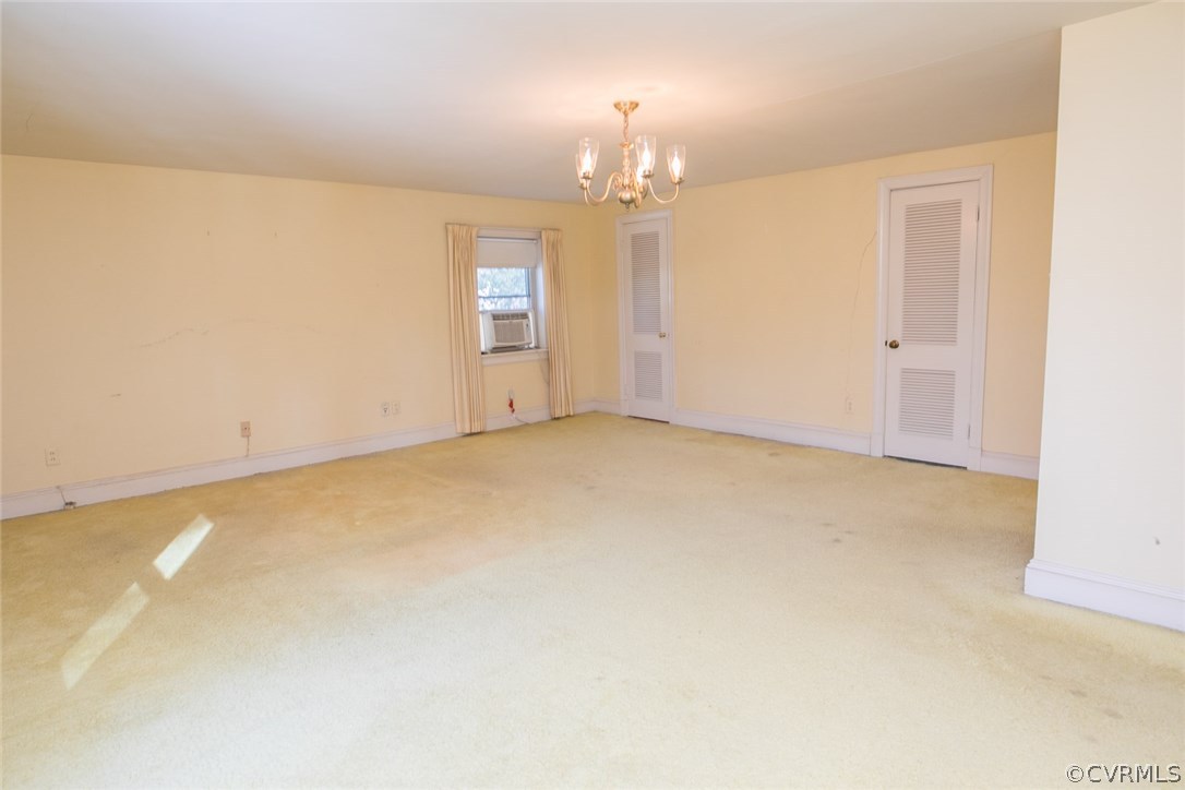 8013 Thom Road Henrico, VA 23229 - Photo 26 of 40 an empty room with a chandelier fan and windows