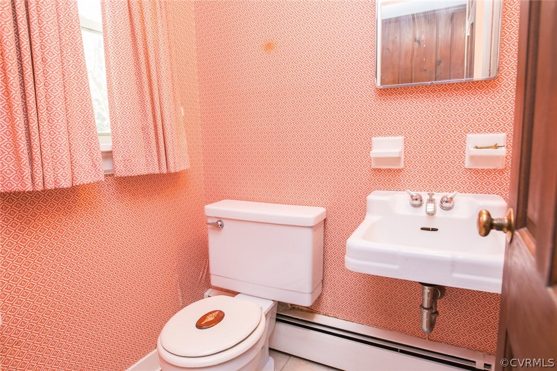 8013 Thom Road Henrico, VA 23229 - Photo 35 of 40 a white toilet sitting next to a bathroom sink