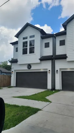 a front view of a house with a garden and yard