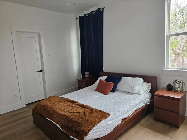 a bedroom with bed and window