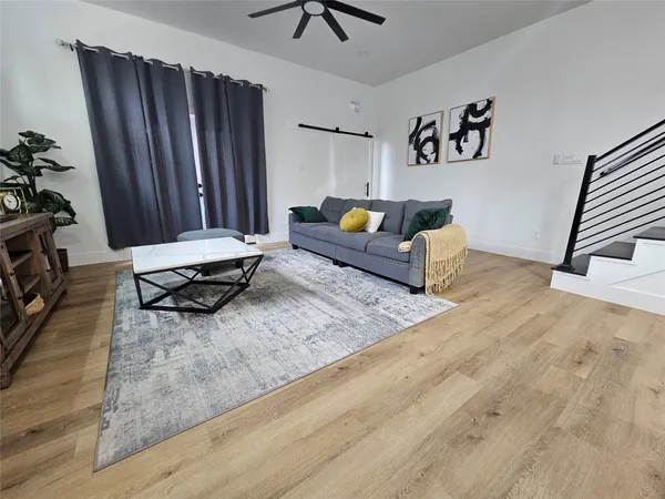 a living room with furniture and a rug