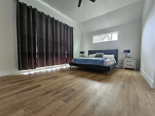 a bedroom with bed and window