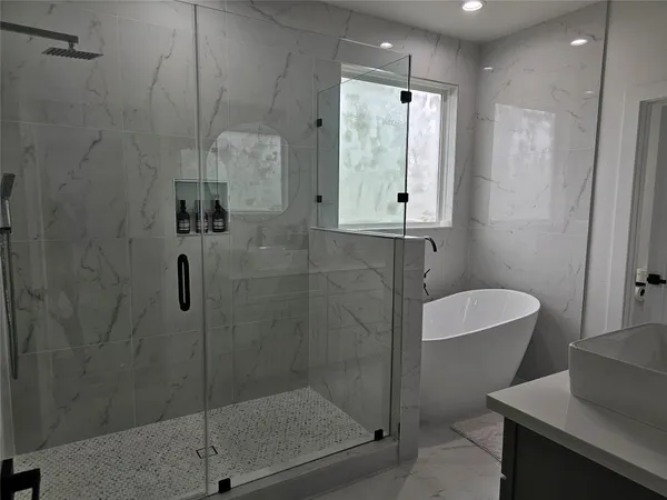 a bathroom with a shower a toilet and sink