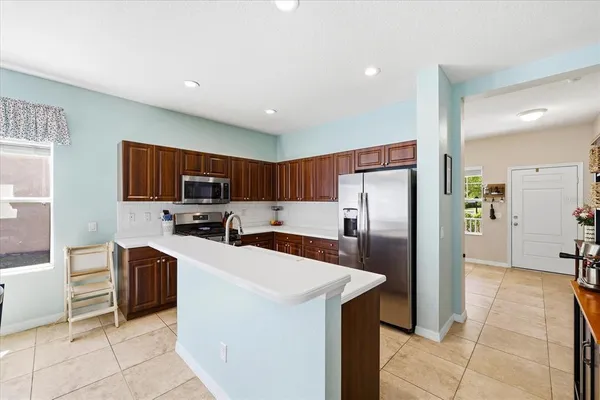 a kitchen with stainless steel appliances a refrigerator and a stove top oven