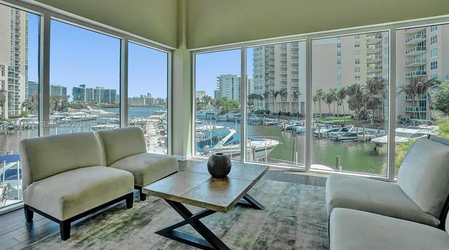 a living room with furniture and a large window