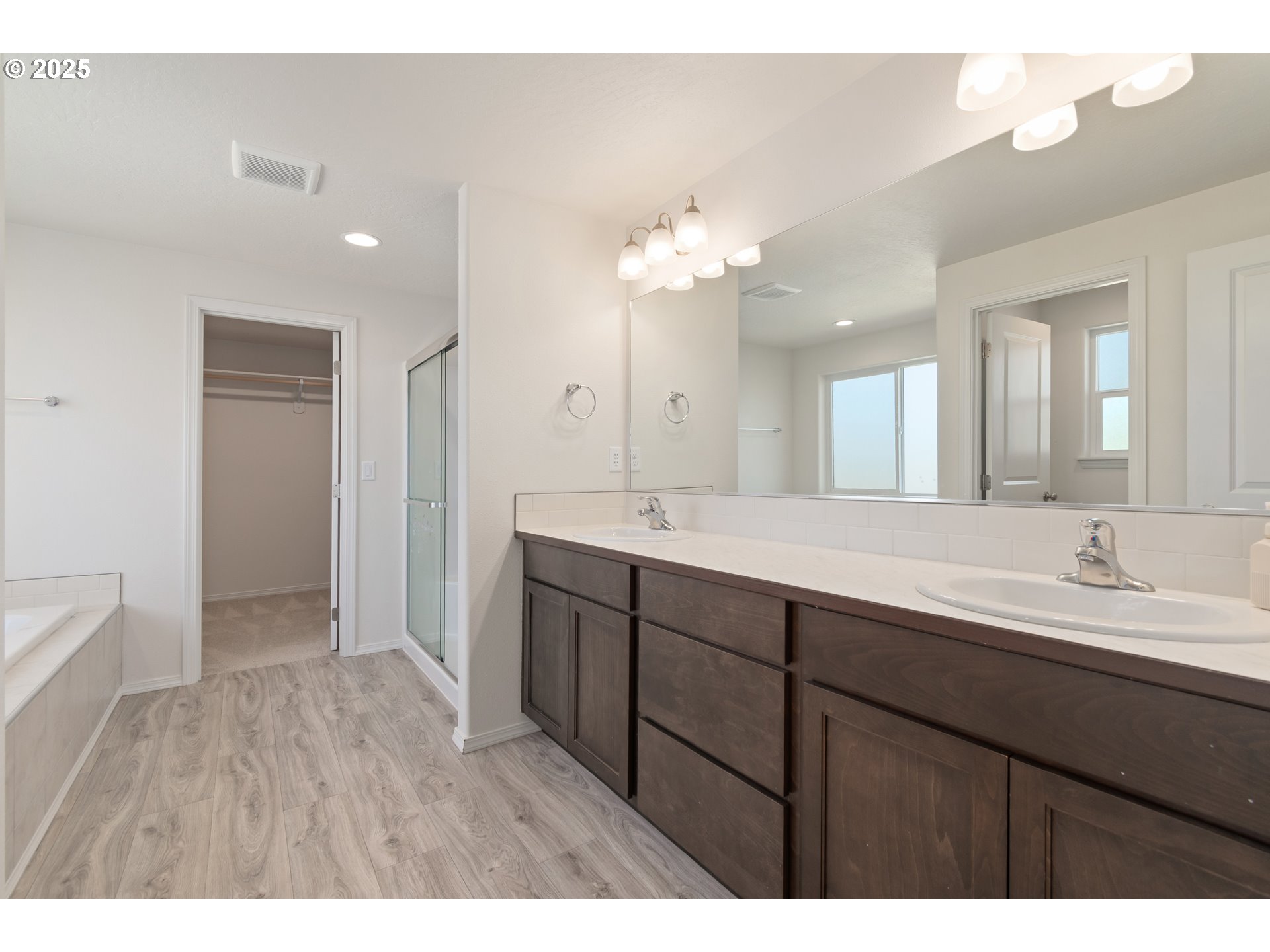 5292 Squirrel Street Springfield, OR 97478 - Photo 21 of 34 a bathroom with a double vanity sink a mirror and a shower