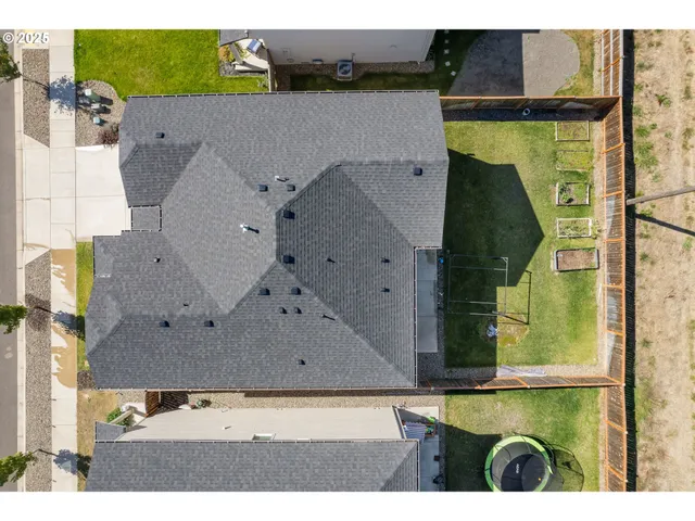 an aerial view of a house with a swimming pool lake view and mountain view