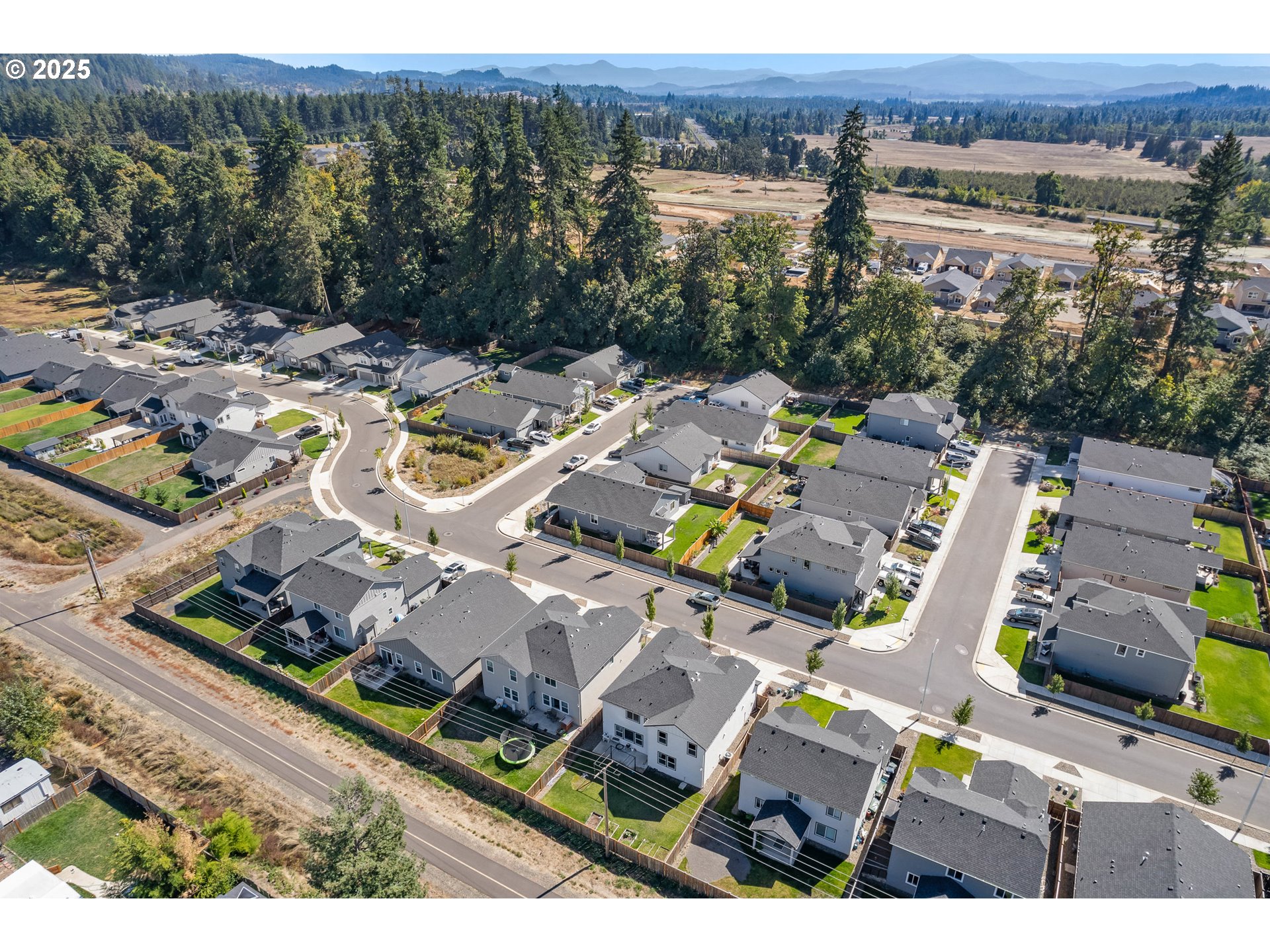 5292 Squirrel Street Springfield, OR 97478 - Photo 34 of 34 an aerial view of a house with a swimming pool lake view and mountain view